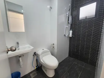 a bathroom with a toilet and a sink and a mirror at Horizon Premium Suite - Ipoh in Ipoh