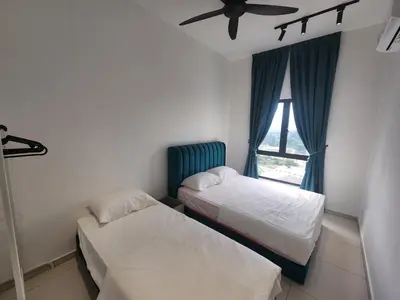 two beds in a room with a window at Horizon Premium Suite - Ipoh in Ipoh