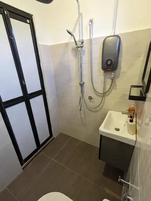 a bathroom with a shower and a toilet and a sink at Villa with Titiwangsa Hill View in Kerling