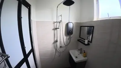 a bathroom with a shower and a sink at Villa with Titiwangsa Hill View in Kerling