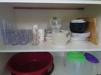 a white shelf with plates and bowls and other items at Villa with Titiwangsa Hill View in Kerling