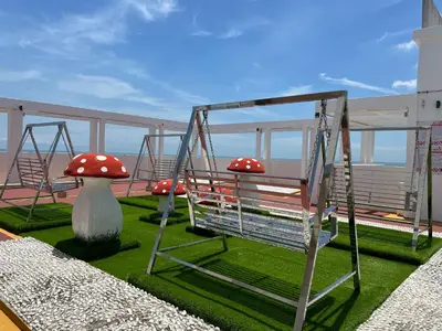 a swing with red mushrooms on top of a ship at Hot Picks SmartTV Netflix Seaview Homestay Sekinchan in Sekincan