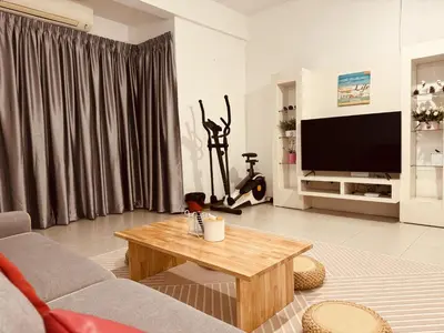 a living room with a couch and a coffee table at Hot Picks SmartTV Netflix Seaview Homestay Sekinchan in Sekincan
