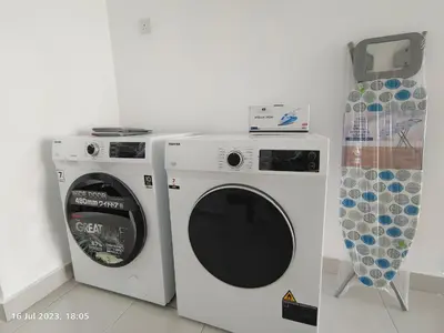 a washing machine and a dryer in a room at Balcony Forest Lake Mountain in Kampar