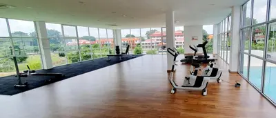 a large room with desks and chairs in a building with windows at Balcony Forest Lake Mountain in Kampar