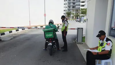 a man standing next to a child on a motorcycle at Balcony Forest Lake Mountain in Kampar