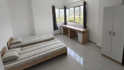 a room with two beds and a window and a bench at Balcony Forest Lake Mountain in Kampar