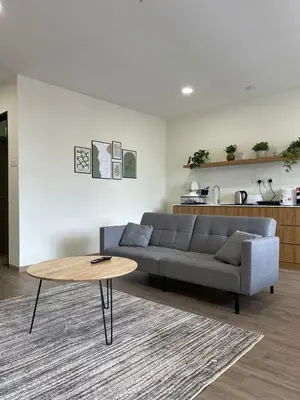 a living room with a couch and a coffee table at Utopia Homestay @ Cameron Centrum in Cameron Highlands