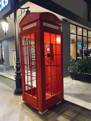 a red phone booth sitting in front of a store at Utopia Homestay @ Cameron Centrum in Cameron Highlands