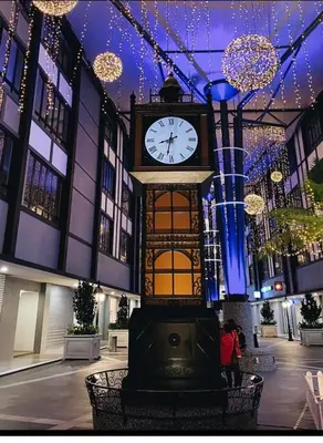 a clock in the middle of a building with lights at Utopia Homestay @ Cameron Centrum in Cameron Highlands