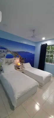 a bedroom with two white beds and a window at The Trails of Kampar in Kampar
