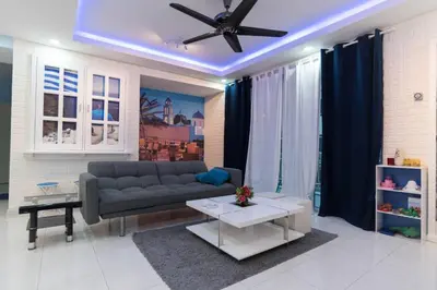 a living room with a couch and a ceiling fan at The Trails of Kampar in Kampar