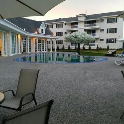 a large building with a swimming pool in a courtyard at The Trails of Kampar in Kampar