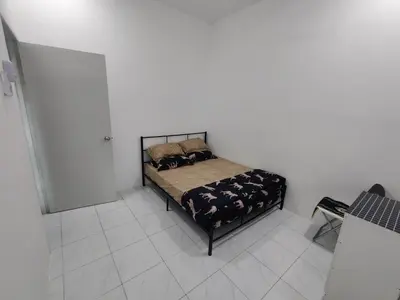 a bedroom with a bed with two pillows on it at Zh homestay teluk batik in Lumut