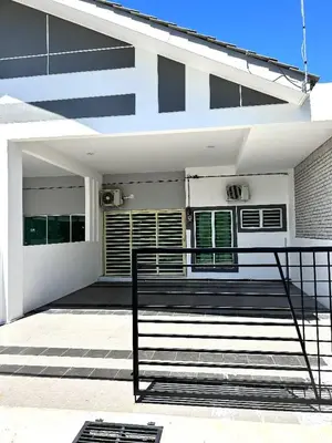 a white house with a bench in front of it at Zh homestay teluk batik in Lumut