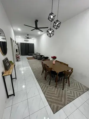 a living room with a table and a couch at Zh homestay teluk batik in Lumut