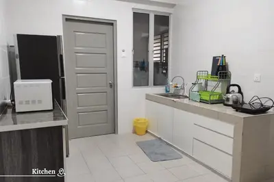 a white kitchen with a sink and a refrigerator at Time Homestay (6-8pax) The Venus, Manjung/Sitiawan in Sitiawan