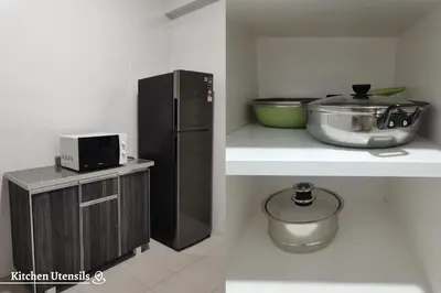 a kitchen with a black refrigerator and a bowl on a counter at Time Homestay (6-8pax) The Venus, Manjung/Sitiawan in Sitiawan