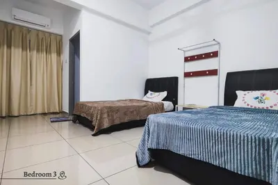 a bedroom with two beds in a room at Time Homestay (6-8pax) The Venus, Manjung/Sitiawan in Sitiawan