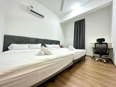 a bedroom with a large white bed and a chair at Ipoh Cozy Homestay by Comfort Home in Ipoh