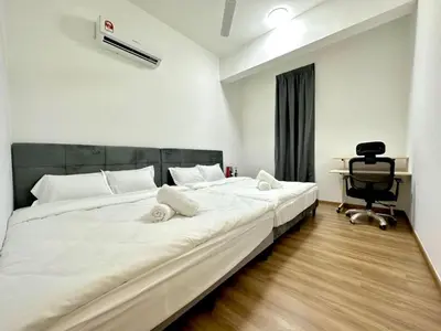 a large white bed in a room with a desk at Ipoh Cozy Homestay by Comfort Home in Ipoh