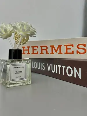 a bottle of hermes perfume sitting next to a sign at Ipoh Cozy Homestay by Comfort Home in Ipoh