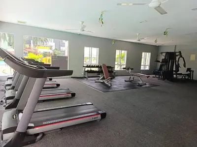 a gym with a treadmill and other equipment in a room at Honeyz Waterpark Homestay. in Ipoh