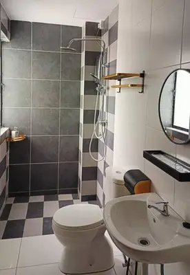 a bathroom with a shower and a toilet and a sink at Honeyz Waterpark Homestay. in Ipoh