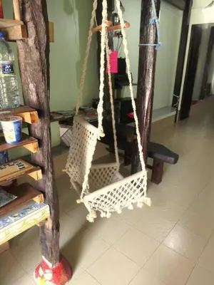 a rope swing in a room with a shelf at Pangkor Guesthouse SPK in Pangkor