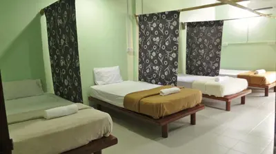 a room with three beds in a room at Pangkor Guesthouse SPK in Pangkor