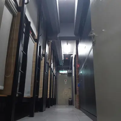 an empty hallway in a building with a hallway at BRICKS Backpackers Sleepbox in Tanah Rata