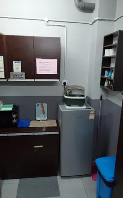 a kitchen with a small refrigerator in a room at BRICKS Backpackers Sleepbox in Tanah Rata