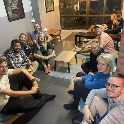 a group of people sitting in a room at BRICKS Backpackers Sleepbox in Tanah Rata