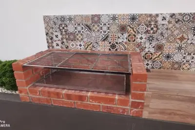 a brick barbecue grill on a wall with a mosaic at Kulim Mini HomeStay in Kulim