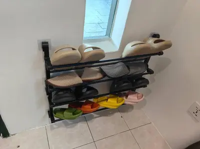 a bunch of shoes on a shelf in a room at Kulim Mini HomeStay in Kulim