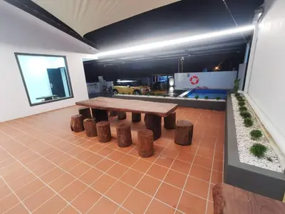 a room with a wooden table and some logs at Kulim Mini HomeStay in Kulim