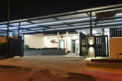 a house with a lit up garage at night at Kulim Mini HomeStay in Kulim