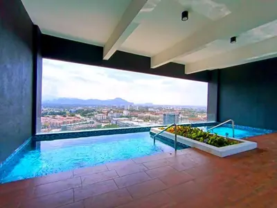 a large swimming pool with a view of a city at Urbanite Premier Suite - Horizon Ipoh by Grab A Stay in Ipoh