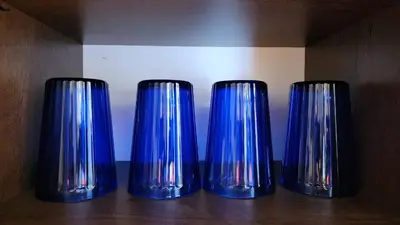 three blue glass vases sitting on a wooden shelf at Urbanite Premier Suite - Horizon Ipoh by Grab A Stay in Ipoh
