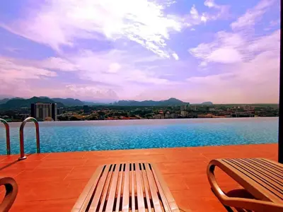 a bench sitting on a deck with a view of a lake at Urbanite Premier Suite - Horizon Ipoh by Grab A Stay in Ipoh