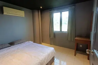 a bedroom with a bed and a window at Coral Bay \u5c0f\u578b\u516c\u5bd3 in Pasir Bogak