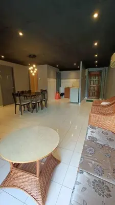 a room with a table and chairs and a dining room at Coral Bay \u5c0f\u578b\u516c\u5bd3 in Pasir Bogak