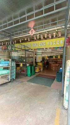 a store with a yellow sign in a building at Coral Bay \u5c0f\u578b\u516c\u5bd3 in Pasir Bogak