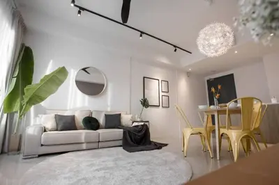 a living room with a white couch and a table at Comfy Stay x 218 Macalister 2BR (Georgetown) \u4e54\u6cbb\u5e02\u4e2d\u5fc3 in George Town