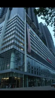 a tall glass building with a flag in front of it at Comfy Stay x 218 Macalister 2BR (Georgetown) \u4e54\u6cbb\u5e02\u4e2d\u5fc3 in George Town