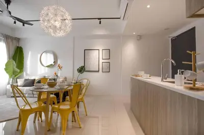 a dining room with a table and yellow chairs at Comfy Stay x 218 Macalister 2BR (Georgetown) \u4e54\u6cbb\u5e02\u4e2d\u5fc3 in George Town
