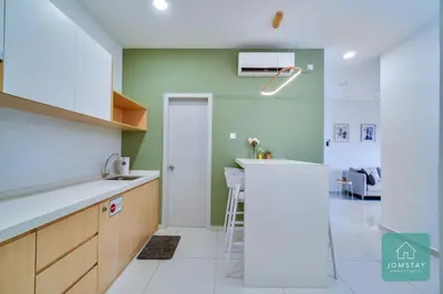 a kitchen with green walls and a white counter top at JOMSTAY - Horizon Suites Ipoh Town Skypool in Ipoh
