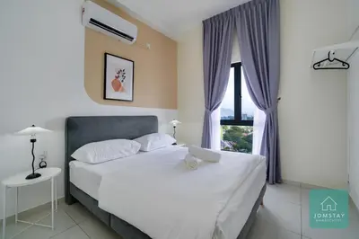 a bedroom with a white bed and a window at JOMSTAY - Horizon Suites Ipoh Town Skypool in Ipoh