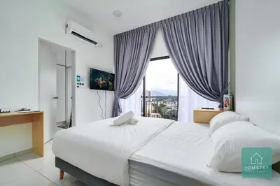 a bedroom with a large white bed with a window at JOMSTAY - Horizon Suites Ipoh Town Skypool in Ipoh