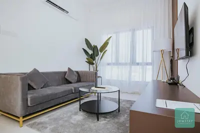 a living room with a couch and a table at JOMSTAY - Horizon Suites Ipoh Town Skypool in Ipoh
